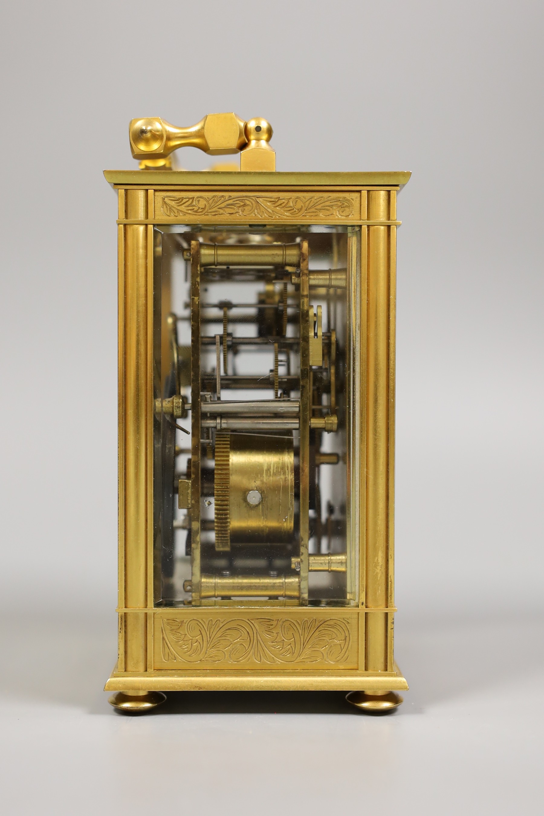 A French repeating carriage clock with alarm and with inlaid scroll decoration, with key, 19cm tall